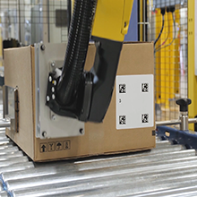 Robotic labeling integration label on box print and apply